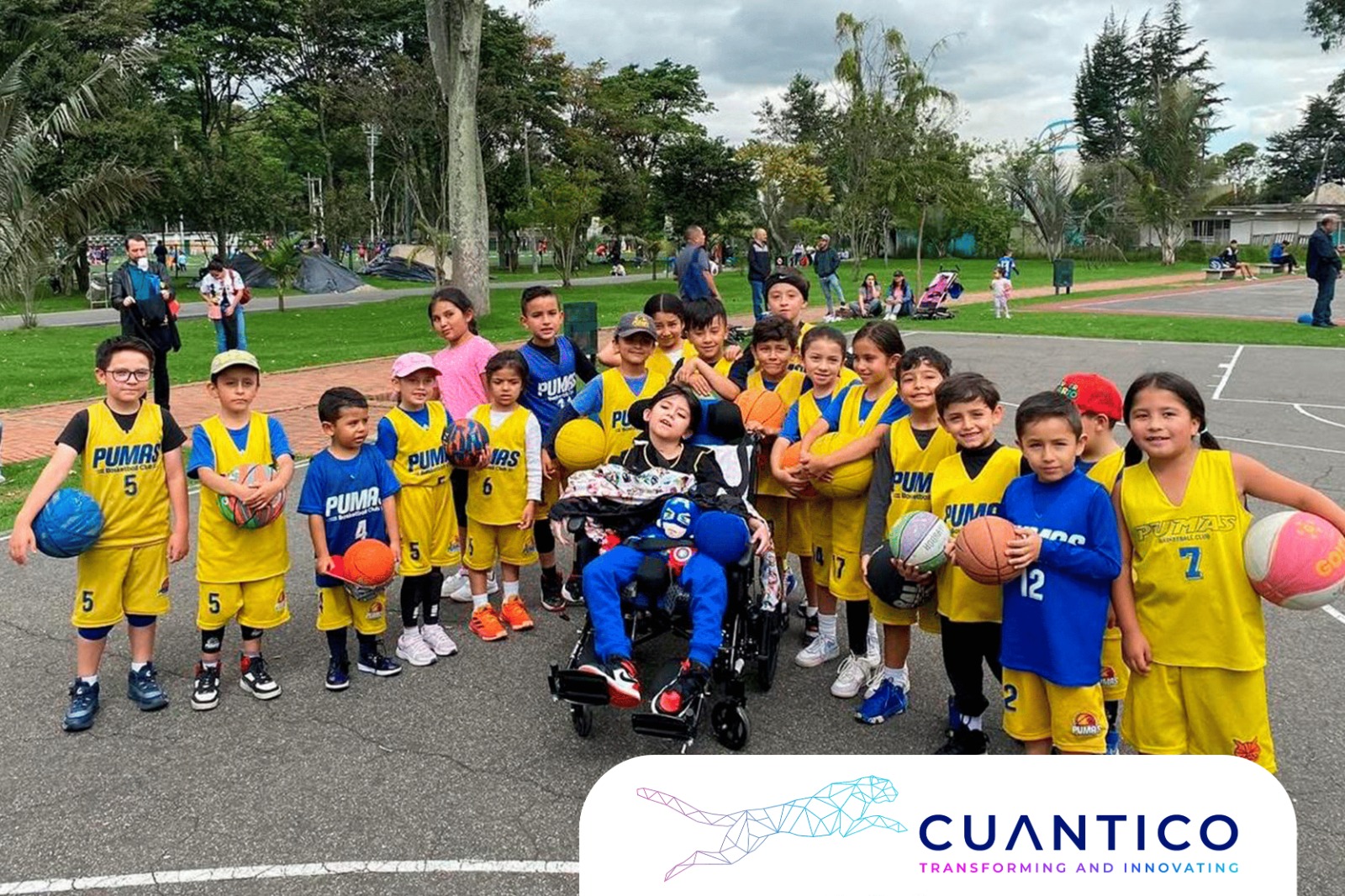 Niños del festival baloncesto infantil Bogotá en jornada de integración Grupo de niños y niñas del Club Pumas en el Festival de Baloncesto Infantil Bogotá, junto a un niño en silla de ruedas, promoviendo inclusión.